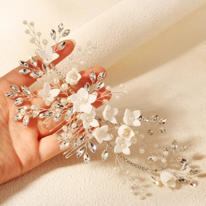 Handmade bridal hair comb with elegant white ceramic flowers pearls and crystals