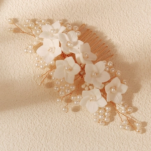 Elegant bridal hair comb with white flowers, pearls, and gold metal wire detailing