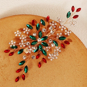 Detailed macro view of handmade bridal hair clip with emerald crystals and pearls