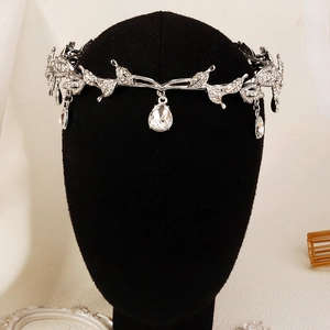 Detailed macro view of vintage silver bridal tiara with leaf patterns and rhinestones