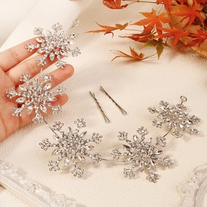 Close-up of sparkling rhinestone snowflake bridal headband with silver hair clips