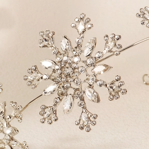 Elegant silver bridal snowflake headband with sparkling rhinestones for wedding hair styling
