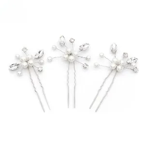 Detailed view of silver hair pins set featuring white pearls and marquise cut rhinestones