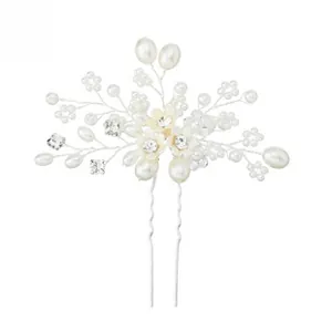 Detail of handcrafted bridal hair pin with white pearls and clear crystal flowers