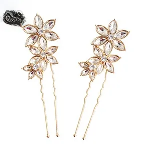 Detailed macro view of golden flower hair pins with crystals and pearls for bridal hair