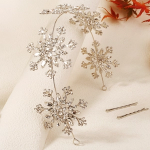 Bridal snowflake headband with sparkling rhinestones and matching hairpins on a textured base