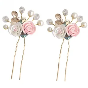 Detail showing pink resin flowers and white pearls on golden bridal hair pins