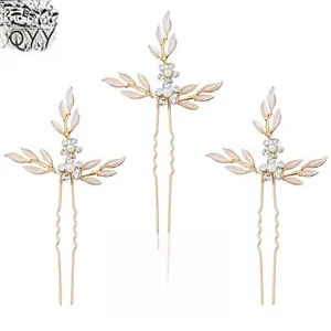 Detailed view of 3-pack gold U-shaped hair pins with white pearls and flower leaves
