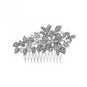 Detailed close-up of a silver bridal hair comb with rhinestone floral and leaf motifs