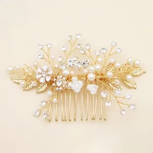 Detail of bridal hair comb featuring handmade pearls, rhinestones, and gold floral branches