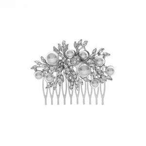 Detailed view of silver wedding hair comb with white pearls and sparkling rhinestones