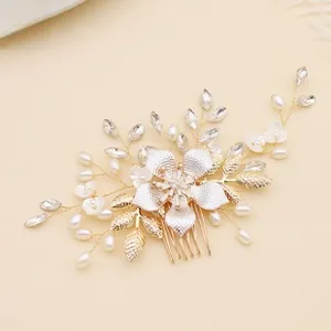 Detailed close-up of handmade gold hair comb with white pearls and sparkling crystals