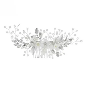 Detail of silver bridal hair comb with resin flowers, marquise rhinestones and pearls