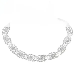 Detail view of handmade bridal hairband with crystal floral patterns and white silk ribbons