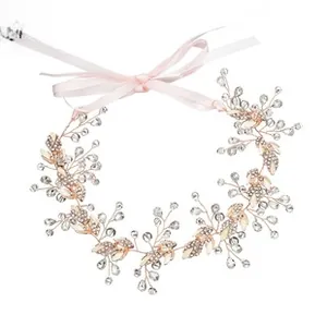 Detail of bridal hairband featuring gold leaves, white pearls and sparkling crystals