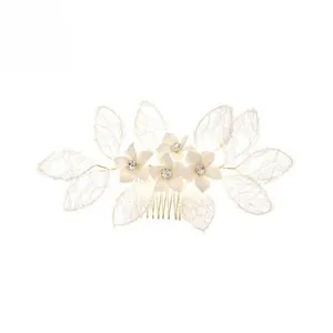 Detailed close-up of handmade bridal hair comb with colorful rhinestones and lace leaves