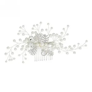 Detail of luxury bridal hair comb featuring white pearls and sparkling rhinestones