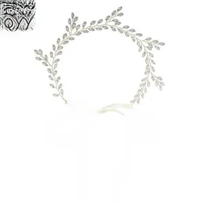 Detail of handmade gold vine headband with silver crystal leaves and white ribbons