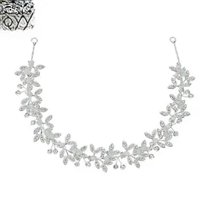 Macro detail of silver bridal hair vine with crystal leaves and white pearls