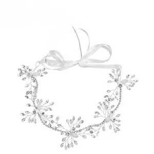 Detail of handcrafted bridal headband with silver wire, white beads, and satin ribbons