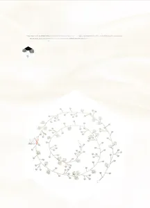 Detailed shot of handmade bridal hair vine with white flowers and pearls on gold wire