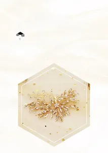 Macro detail of handmade bridal hairpin with gold wires, rhinestones, and crystal leaves
