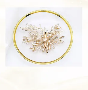 Detailed close-up of handmade bridal hair clip with crystals and copper wire floral motif