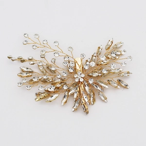 Handmade bridal hair clip with gold leaf design and sparkling clear rhinestones