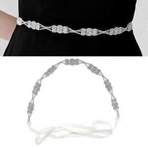 Detail of bridal rhinestone flower belt with silver crystal chain and white satin ribbon tie