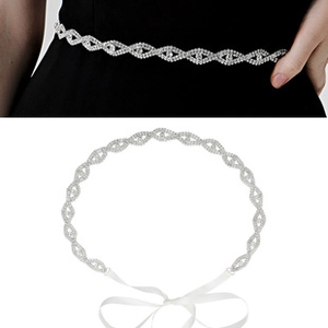 Detail view of rhinestone bridal belt with diamond pattern and white ribbon ties