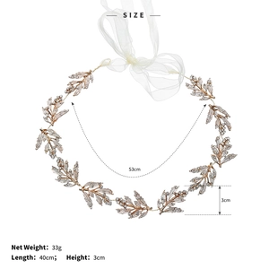 Detail of leaf-shaped bridal headband with rhinestones and white silk ribbon ties