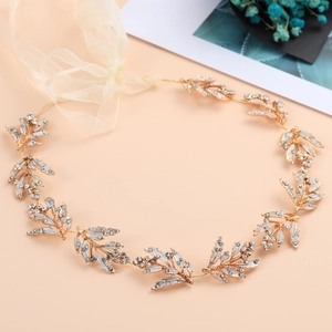 Detailed view of handmade golden leaf bridal headband with sparkling rhinestones and ribbons