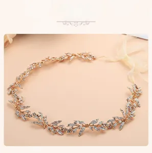 Macro detail of bridal belt with golden leaves and sparkling rhinestones on ribbon