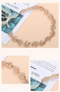 Detail view of gold bridal belt featuring leaf patterns and crystal rhinestone inlay