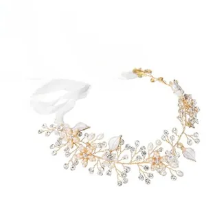 Detail of bridal hair vine with handmade pearls, rhinestones and white enamel leaves