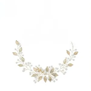 Detailed view of handmade bridal vine headband with golden leaves and white pearls