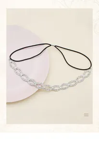 Detail of the sparkling rhinestone wave pattern and black elastic band on the bridal headband
