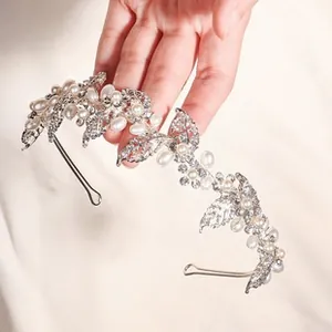 Detail of silver alloy bridal headband with white pearls and clear crystal leaves