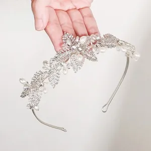 Detailed view of handmade silver crystal headband with pearls and floral rhinestone patterns