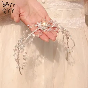 Detail of silver bridal headband with pink crystals and handcrafted floral beadwork