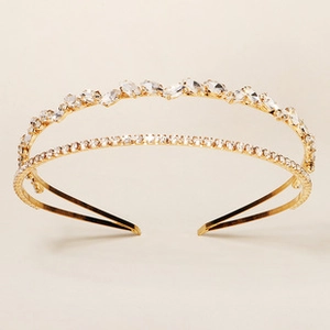 Detail of a double-layered golden headband featuring marquise and round crystals