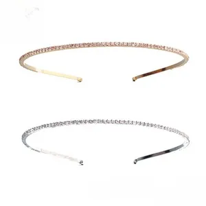 Detail of thin gold and silver headbands with sparkling rhinestones on white backdrop