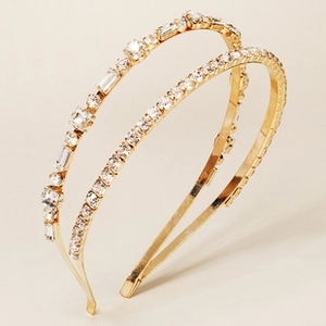 Detailed close-up of a double-layered golden headband with sparkling crystal rhinestones