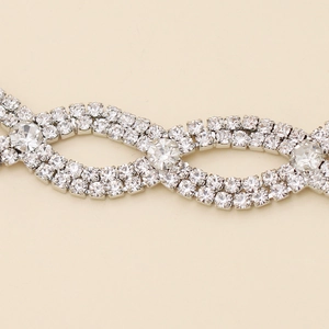 Macro detail showing infinity-shaped silver bridal headband with sparkling rhinestones