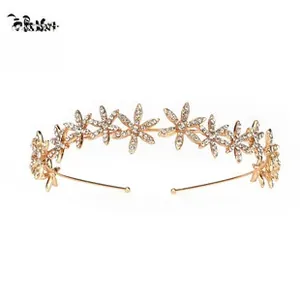 Detailed view of golden bridal headband featuring floral patterns with white rhinestones
