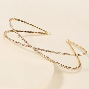 Detailed close-up of a double-layered gold hairband with sparkling white rhinestones