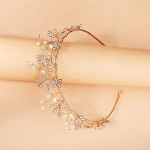 Detailed macro view of champagne gold bridal headband with rhinestones and white pearls