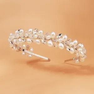 Detailed shot of bridal headband featuring sparkling crystals and white faux pearls