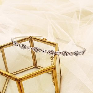 Close-up of elegant silver double-layer headband with rhinestones and alloy leaves on tulle