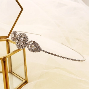 Close-up of sparkling rhinestone headband on a jewelry box with elegant hanging chains
